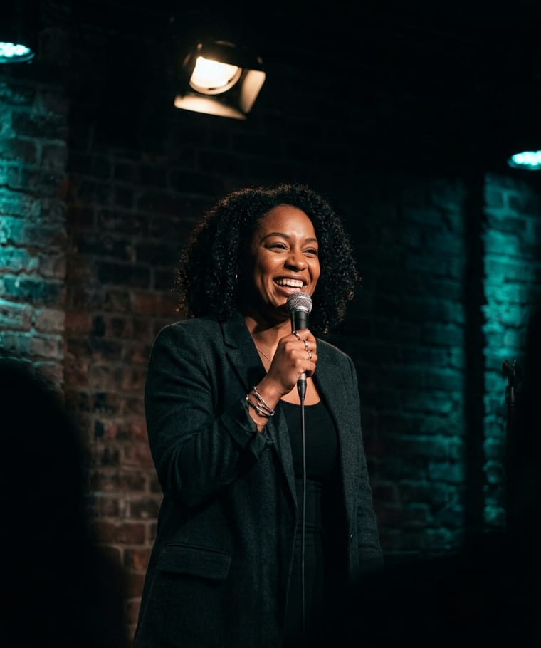 A stand-up comedian at the mic in an intimate club